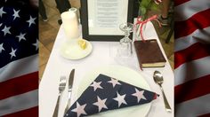 a place setting with an american flag napkin and silverware