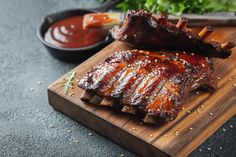 ribs on a cutting board with sauce and parsley