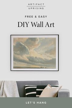 a living room with a couch and painting on the wall above it that reads, free & easy diy wall art let's hang