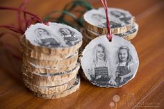 three wooden slices with pictures on them hanging from red twine string and some other decorations