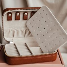 Keep all of your precious jewels in place with our lush jewellery travel case in a classy dark tan. We've worked hard to bring you just the right amount of storage for at home or on the go in the form of this vegan-friendly pebble leather case! Perfect for popping into your weekend bag, suitcase, gym bag or wherever your travels may take you. Keep your pendants tangle-free in the five hanging tabs and corresponding pouch and your rings or earrings in the lined and subdivided base compartments. I Elegant Rectangular Jewelry Storage For Daily Use, Luxury Cases With Interior Card Slots For Everyday, Luxury Case With Interior Card Slots, Elegant Compact Jewelry Storage For Everyday Use, Compact Portable Jewelry Storage For Everyday, Everyday Leather Jewelry In Rectangular Shape, Everyday Rectangular Leather Jewelry, Timeless Rectangular Brown Jewelry, Classic Portable Cases For Gifts