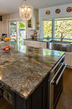 a large kitchen island with granite counter tops