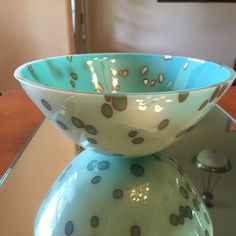 a blue and white bowl sitting on top of a table