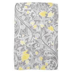 a gray and yellow towel with flowers on it