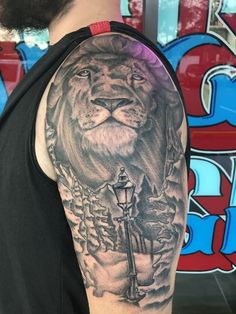 a man with a lion tattoo on his arm