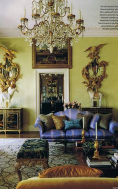 a living room filled with furniture and a chandelier