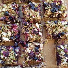 an image of granola bars with blueberries and almonds on top that are cut into squares