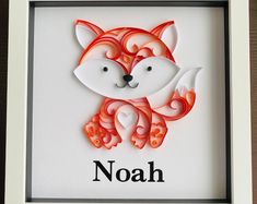 a red and white paper cut animal with the word noah in it's center