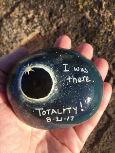 a hand holding a rock with the words i was there totality 8 11 17