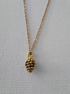 Simple botanical pinecone charm pendant antique gold tone necklace. ♥ Packaging Each item is individually packed in a recycled gift box. ♥ Custom Variety of different chains, please message me if you would like a specific item. ♥ Shipping All items are sent Royal Mail 2nd class. Caring for your jewellery: please remove before showering, swimming or bath for jewellery to last longer. Nature-inspired Brass Necklace For Gift, Nature-inspired Brass Pendant Jewelry, Nature-inspired Nickel Free Gold Necklace, Forest Jewelry, Forest Necklace, Necklace Packaging, Valentine Birthday, Botanical Jewelry, Nature Inspired Jewelry