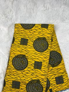 African Fabric/Ankara This yellow African Fabric is high quality African print made from 100% cotton and it's 45 inches wide. It is used for making African Clothing, African quilts, & For Home decoration. FYI: Print is Double sided. The listing is for 1, 6 yards and Headwrap Each piece of fabric measures:  36in by 45in for 1 yard 216in by 45in for 6 yards 70in by 22in for Head wrap If you purchase more than one yard, you will receive one continuous piece. *If you require more than what I have listed, feel free to send me email. CARE INSTRUCTIONS: *DO NOT BLEACH *Hand wash with cold water and mild soap or Dry clean *Press with hot iron for a crispy look. Color may be different due to your monitor Traditional Yellow Cotton Fabric, Yellow Traditional Cotton Fabric, Printed Yellow Ankara Fabric, Yellow Printed Ankara Fabric, African Party Dresses, African Quilts, African Wedding Dress, Fabric Display, Block Print Fabric