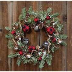 a christmas wreath hanging on a wooden wall