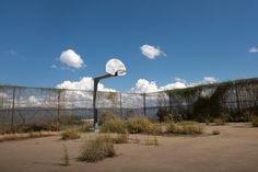 an old basketball hoop in the middle of nowhere