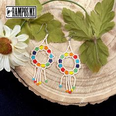 Beautiful Handmade Mexican Earrings , Mexican Shakira Earrings , Bohemian Boho earrings. 100% Handmade Handcraft by great Artisans in Mexico , These lovely Ear Wire earrings are extremely light and can be worn on all everyday occasions specially if you like colorful and fresh accessories. Aprox Size : 3 1/4 inches length & 1 3/8 inch wide Every piece is unique and color might change a little , depending on the screen device its been viewed on Aretes Mexicanos de Shakira , hecho a mano , Arte for Multicolor Beaded Flower Drop Earrings, Multicolor Beaded Drop Flower Earrings, Adjustable Multicolor Flower Earrings With Colorful Beads, Multicolor Beaded Flower Earrings For Festivals, Dangle Flower Earrings With Ear Wire For Festival, Multicolor Handmade Teardrop Flower Earrings, Handmade Multicolor Teardrop Flower Earrings, Multicolor Teardrop Hoop Earrings Bohemian Style, Traditional Multicolor Flower Earrings With Dangling Beads