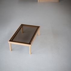 a small table with a glass top on the floor