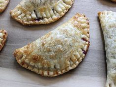 several pieces of pie sitting on top of a wooden cutting board next to each other