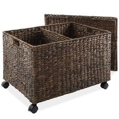 two brown baskets sitting on top of each other with black casteors and wheels in front of them