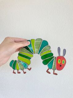 Inspired by Eric Carle's The Very Hungry Caterpillar! Stained glass sun catcher handmade art. Stained Glass Caterpillar, Hungry Caterpillar Art, Stained Glass Sun, Panels Wall, Nursery Room Inspiration, Stained Glass Suncatchers, The Very Hungry Caterpillar, Stained Glass Panel, Glass Designs