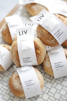 bread rolls wrapped in white paper with labels on them