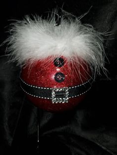 a red ball with white feathers on it