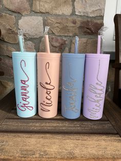 three different colored tumbles with the words happy birthday written on them and one has a straw in it