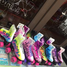 colorful skateboards lined up in front of a store window