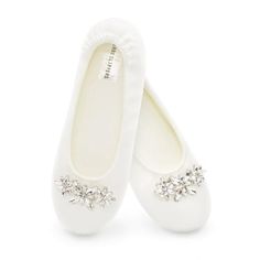 two pairs of white shoes with bows and pearls on the bottom, one in satin