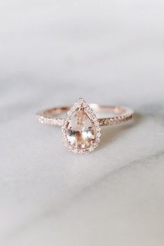 an engagement ring with a pear shaped morganite in the center