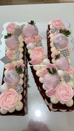 the cake is decorated with pink and white frosting, roses, and other decorations