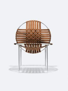 a wooden chair sitting on top of a metal frame with a circular seat and backrest