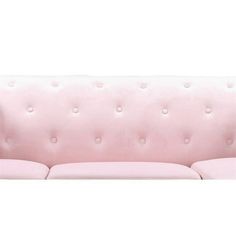 a pink couch with buttons on the back and arms, sitting in front of a white background