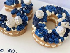 two blue and white decorated donuts sitting on top of a cake