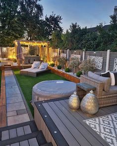 an outdoor living area is lit up at night with lights on the patio and lawn furniture