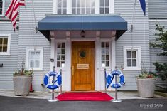 the front entrance to a hotel with an american flag