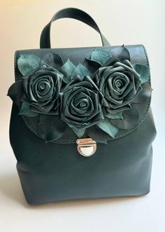 Rose green womens leather backpack  is my author's manual work! Materials: genuine dark green leather, metal hardware. Sizes: 9 inches (width), 10 inches (highth), 5 inches (depth). There is a beautiful decoration with three roses on the front side of the backpack. The small leather backpack purse for women has one handle, two adjustable straps and three pockets inside: one zipped and two flat ones. My colorful green flower leather bag and other leather goods may be great birthday gifts, bridesm Leather Backpacks For Women, Womens Leather Backpack, Small Leather Backpack, Three Roses, Backpacks For Women, Manual Work, Leather Backpack Purse, Leather Backpacks, Rose Green