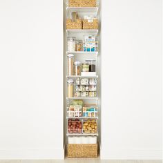 the pantry shelving unit is organized with baskets, food items and other things in it