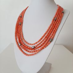 Necklace with five strands of Mediterranean coral of a very light color, which can be defined as peach-pink. The coral is coralium rubrum, from Sardinia, precisely from the Bosa area. The minimum circumference of the necklace is 47 cm. and the maximum is 56 cm. The shortest coral strand is 42cm. and the longest one is 51 cm. Coral grains are 5.5 to 6 mm wide. and 3.7 to 4.85 mm long. The coral is handmade, the color is natural, without any color enhancement. In Italy, this color is called "The b Coral Beaded Multi-strand Necklace, Multi-strand Coral Beaded Necklace As Gift, Coral Multi-strand Beaded Necklace For Gift, Multi-strand Coral Beaded Necklace For Gift, Coral Multi-strand Necklace As Gift, Multi-strand Coral Necklace For Gift, Coral Multi-strand Necklace For Gift, Purchase Invoice, Natural Coral