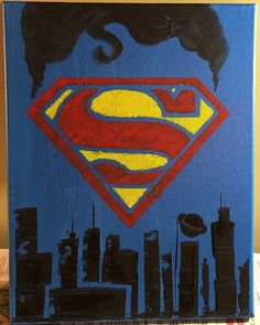 a painting of a superman symbol with buildings in the background