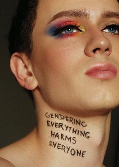 a woman with words on her face and neck that read gendering everything harms everyone