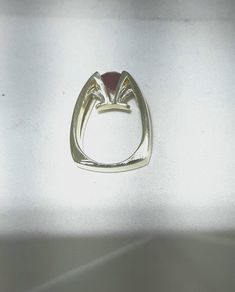 Eddie Sakamoto custom made 18k yellow gold ring. Set, suspended like, in a 4 prong head is an 2.75 carat red Rhodalite Garnet. The stone is a bright red. The 2 round diamonds are set in a tight prong style setting. The diamonds weigh .20 carat with Vs1 clarity and F-G color. A statement for sure. The band weighs 18.5 grams and is a size 8 Eddie Sakamoto is a well known Northwest designer. Platinum Engagement Rings Vintage, Garnet And Diamond Ring, Platinum Wedding Band, Unusual Rings, Garnet Gem, Platinum Wedding, Montana Sapphire, Platinum Engagement Rings, Red Band