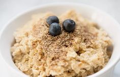 a bowl filled with oatmeal topped with blueberries