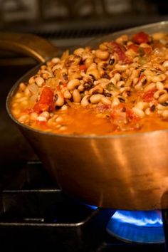 a pot filled with beans on top of a stove