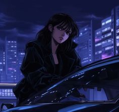 a woman leaning on the hood of a car in front of a city at night