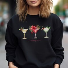 Three gorgeous Christmas cocktails and the words Holiday Cheer are printed on this cozy shirt. Long sleeve, crewneck sweatshirt. Casual Party Sweatshirt, Casual Long Sleeve Party Sweatshirt, Winter Party Sweatshirt With Crew Neck, Winter Party Crew Neck Sweatshirt, Casual Winter Party Sweatshirt, Casual Crew Neck Sweater For Party, Holiday Long Sleeve Sweatshirt As Gift, Chic Holiday, Glam Chic