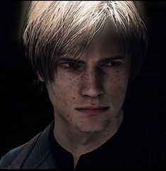 a young man with freckles on his face and hair is staring at the camera