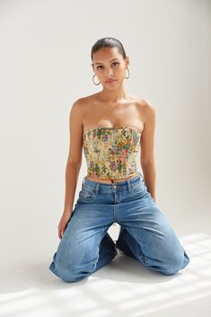 This item is excluded from promotions. Elevate your look with the Wilma Corset Top! This dreamy piece is complete with a strapless sweetheart neckline, a lace up ribbed design at the back, a floral tapestry print, and inner boning for a structured fit. Available in nude with multicolor flowers, neutral with indigo flowers, white with brown flowers and navy & ivory floral. Pair with some denim for a casual streetwear vibe. Details 95% Polyester, 5 Spandex Cropped silhouette Adjustable back tie cl Tapestry Corset, Indigo Flowers, Flowers Neutral, Corset Top Outfit, Indigo Flower, Multicolor Flowers, Nude Outfits, American Threads, Boned Corsets