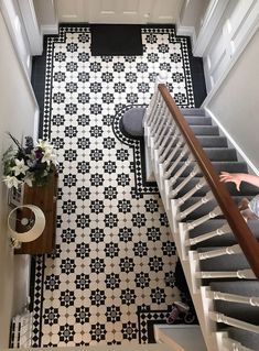 an overhead view of a staircase with black and white tiles