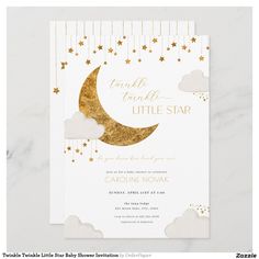 a white and gold baby shower with stars on the moon, clouds and raindrops