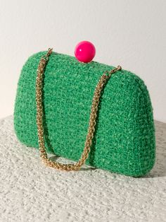 Meet your favorite fall clutch, the Lana Minaudiere from Shiraleah. This versatile bag features a trendy tweed texture in a chic green color pattern with a pink push lock closure. With its interchangeable single handle and cross-body chain, this little purse can be worn as a clutch, a mini bag, or a cross-body! The Lana Minaudiere effortlessly exudes style and sophistication. Pair with other items from the Shiraleah collection to complete your look! Shiraleah is a trend-driven lifestyle brand fo Trendy Green Crossbody Clutch, Green Evening Bag With Chain Strap, Green Clutch With Chain Strap, Chic Green Evening Bag With Chain Strap, Trendy Green Evening Bag For Formal Occasions, Green Pouch Clutch With Detachable Handle, Chic Green Rectangular Clutch, Green Crossbody Clutch For Party, Green Crossbody Evening Bag For Party