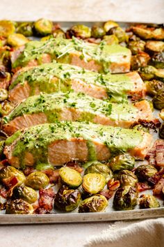 salmon and brussel sprouts on a sheet pan with pesto sauce